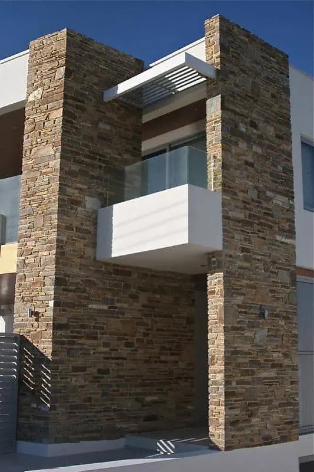 Completed Toodyay Stone cladding on a contemporary two-storey home facade